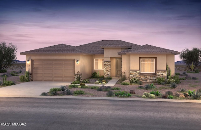 prairie-style home featuring stone siding, concrete driveway, an attached garage, and stucco siding