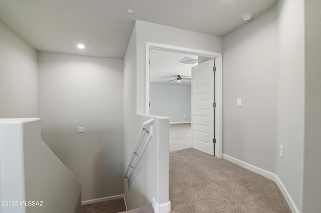 hall with recessed lighting, carpet flooring, baseboards, and visible vents