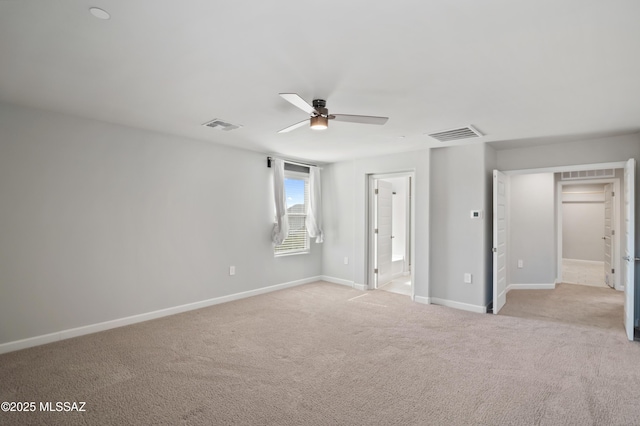 unfurnished bedroom with light carpet, visible vents, connected bathroom, and baseboards