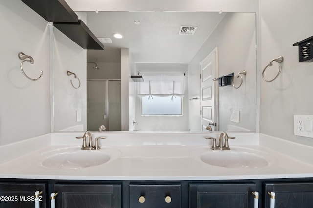 full bathroom featuring double vanity, visible vents, and a sink