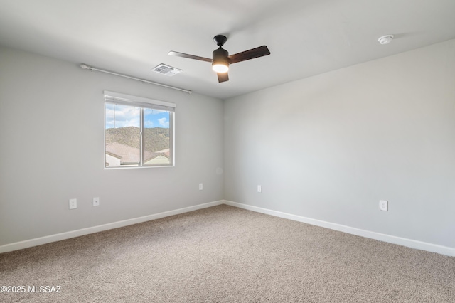 unfurnished room featuring a ceiling fan, carpet flooring, baseboards, and visible vents