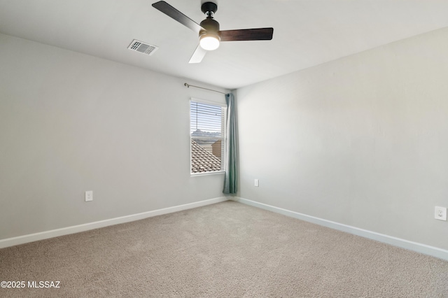 unfurnished room with visible vents, baseboards, and light colored carpet