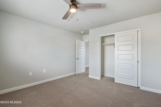 unfurnished bedroom with a closet, baseboards, visible vents, and carpet floors