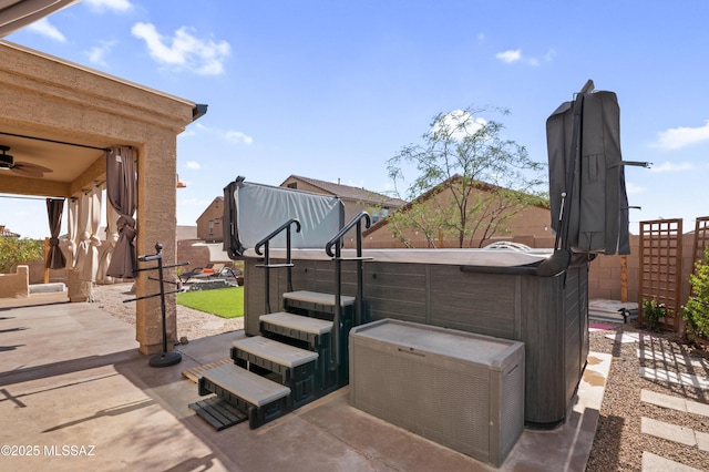 view of patio featuring a fenced backyard and a hot tub