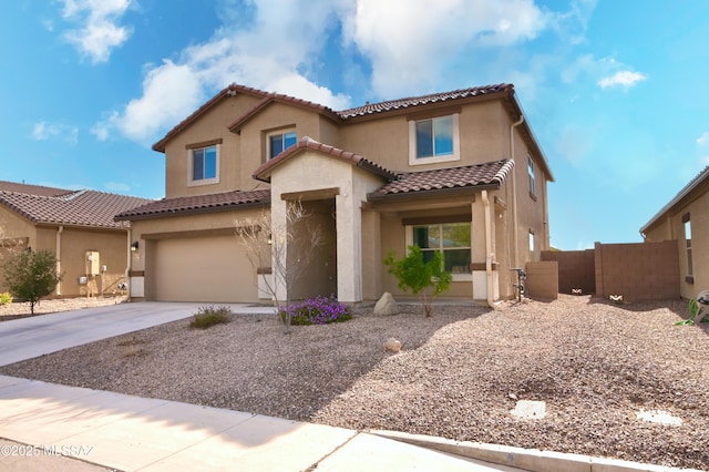 mediterranean / spanish-style home featuring fence, a tiled roof, concrete driveway, stucco siding, and an attached garage