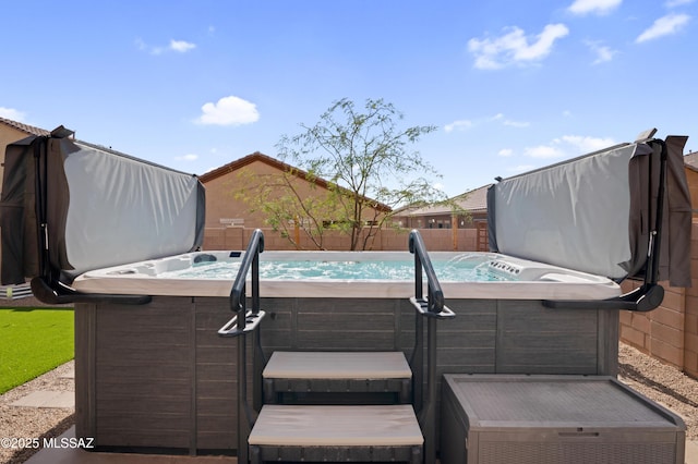 view of patio / terrace with a fenced backyard and a hot tub