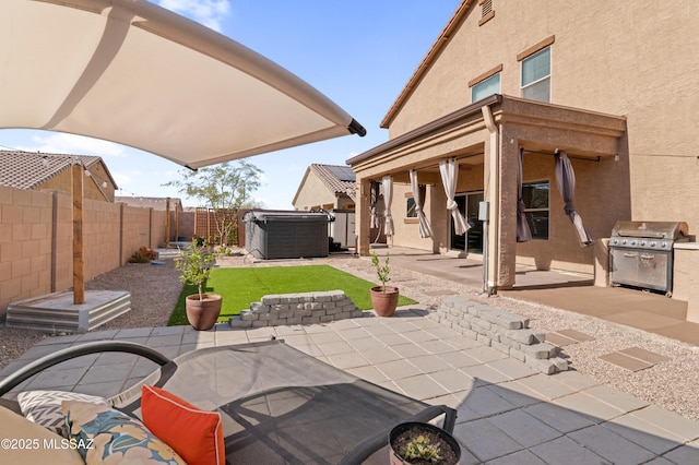 view of patio with area for grilling and a fenced backyard