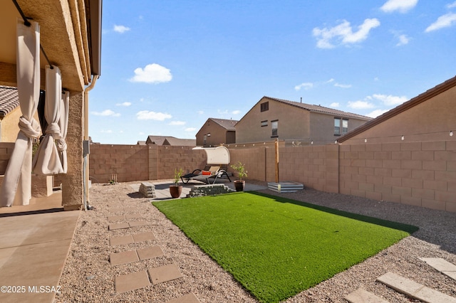 view of yard with a patio area and a fenced backyard