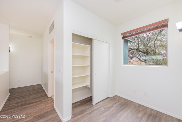 unfurnished bedroom with a closet, visible vents, baseboards, and carpet flooring