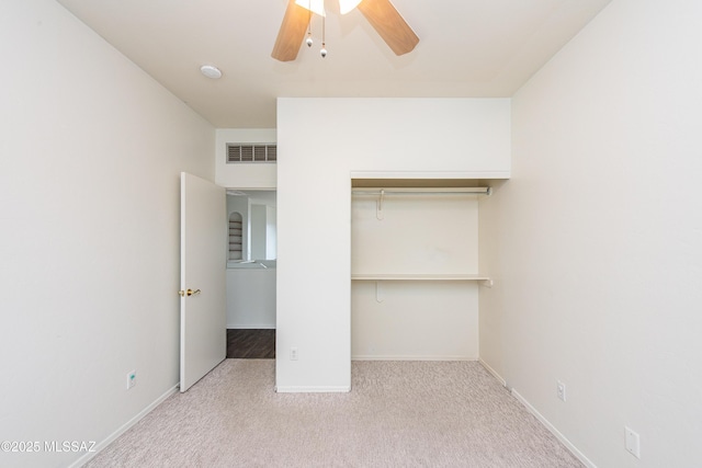 unfurnished bedroom with carpet floors, baseboards, visible vents, and a closet