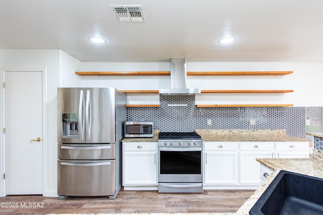 kitchen featuring stainless steel appliances, visible vents, island range hood, and open shelves