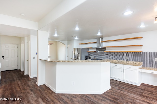 kitchen featuring dark wood finished floors, island exhaust hood, white cabinetry, open shelves, and backsplash