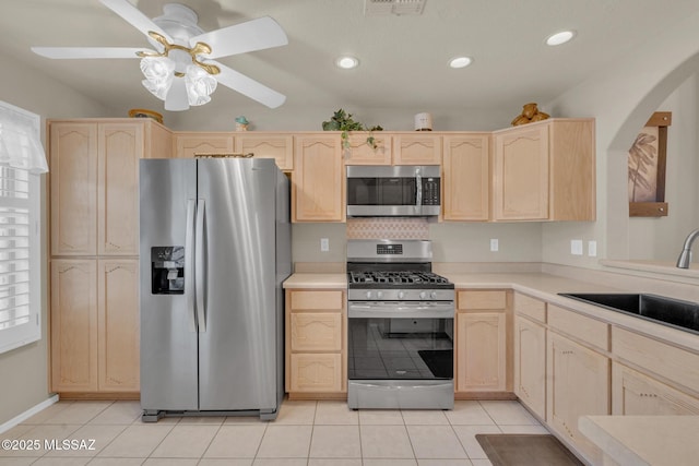 kitchen featuring a sink, light brown cabinets, and stainless steel appliances