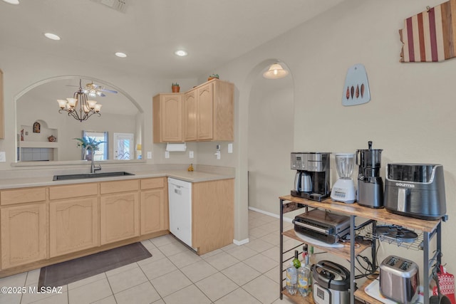 kitchen featuring a sink, light brown cabinetry, white dishwasher, and light countertops