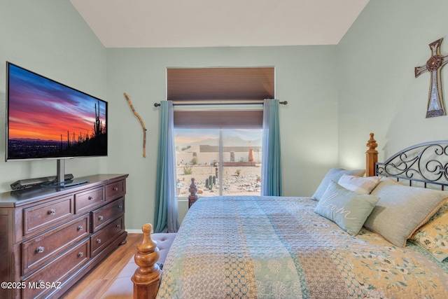 bedroom featuring baseboards and light wood-style flooring