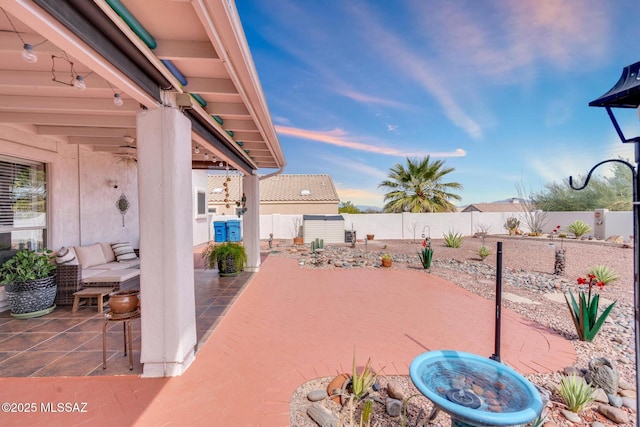 view of patio with an outdoor living space and a fenced backyard