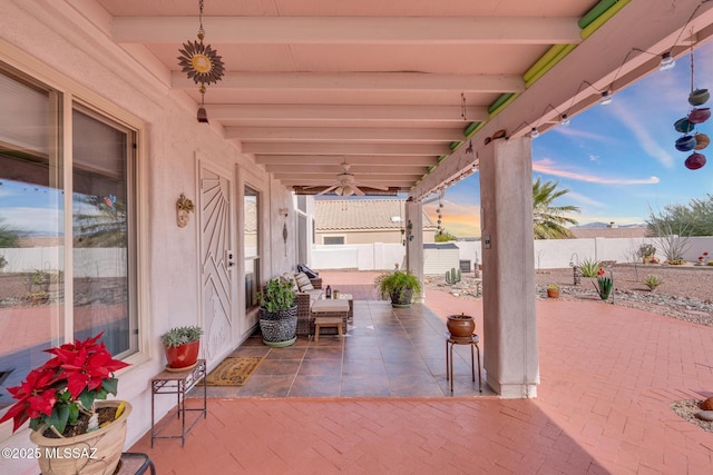 view of patio with a ceiling fan and fence