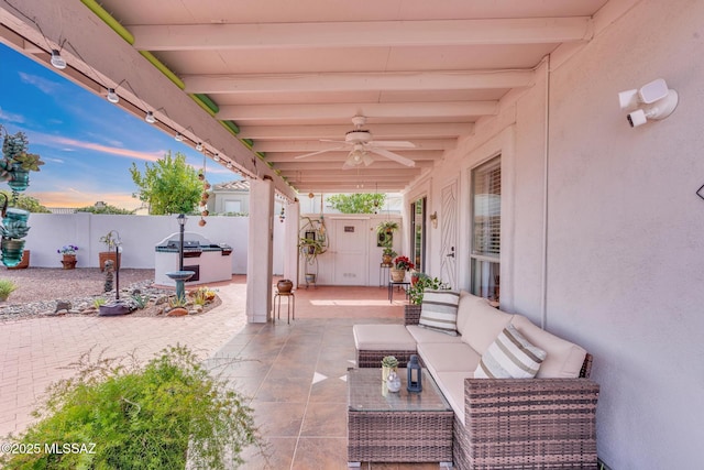 view of patio featuring grilling area, outdoor lounge area, a fenced backyard, and a ceiling fan