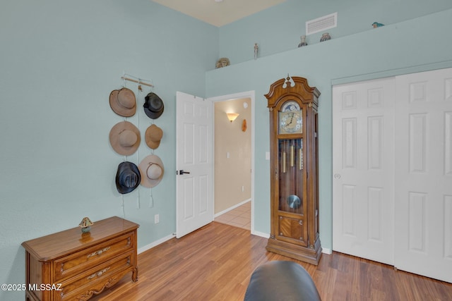 entryway with visible vents, baseboards, and wood finished floors