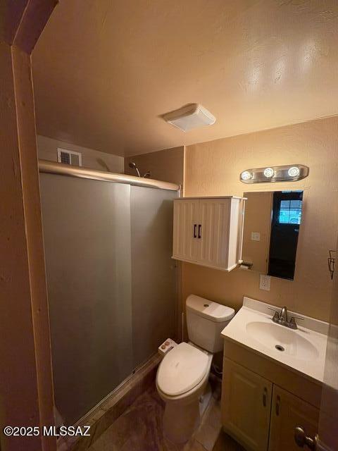 302 W Aragon Rd, Tucson, AZ 85756 - bathroom with a shower stall, vanity, and toilet