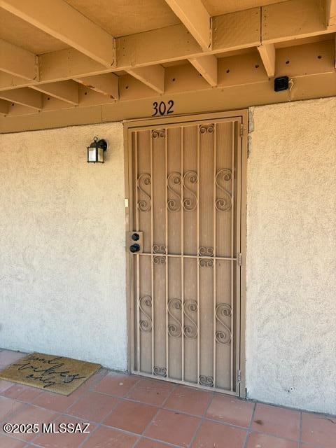 302 W Aragon Rd, Tucson, AZ 85756 - doorway to property featuring stucco siding