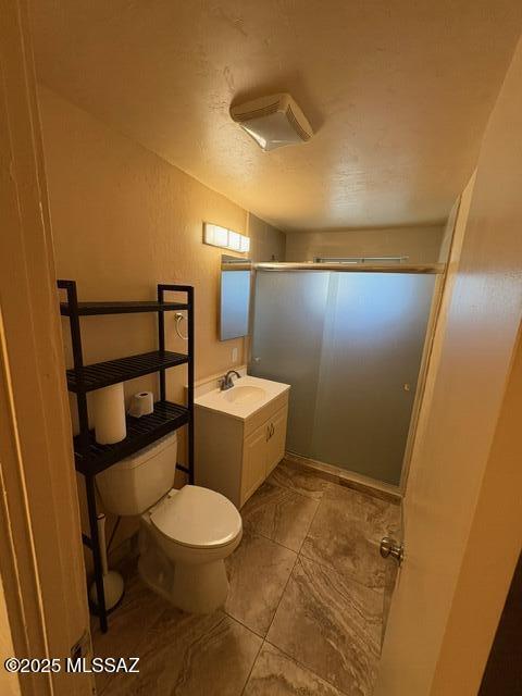 302 W Aragon Rd, Tucson, AZ 85756 - bathroom with a shower stall, toilet, vanity, and tile patterned floors
