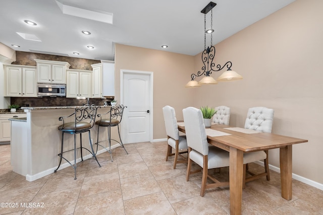 dining area featuring light tile patterned floors, baseboards, and recessed lighting