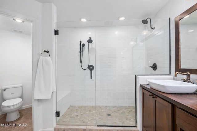 full bath featuring vanity, visible vents, tile patterned flooring, a shower stall, and toilet