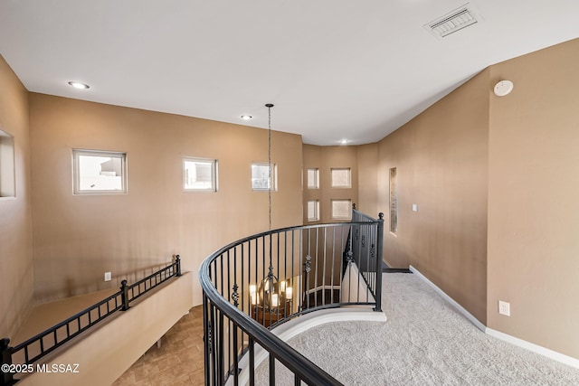 stairway featuring visible vents, recessed lighting, an inviting chandelier, and baseboards