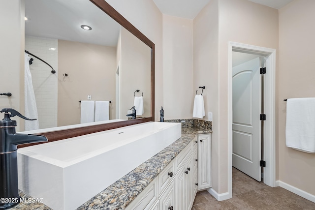 full bath with tile patterned flooring, curtained shower, vanity, and baseboards