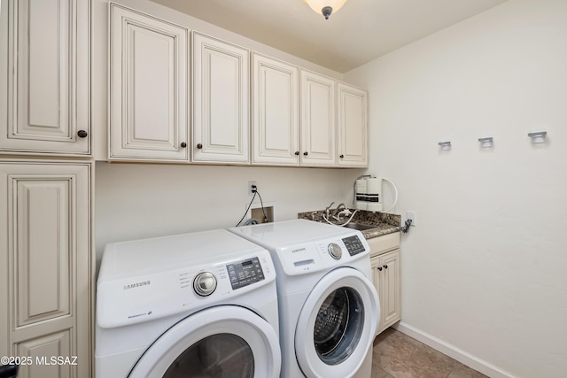 laundry room featuring light tile patterned floors, cabinet space, baseboards, and washer and clothes dryer