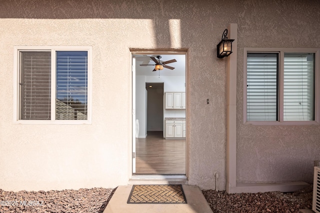 view of exterior entry with stucco siding