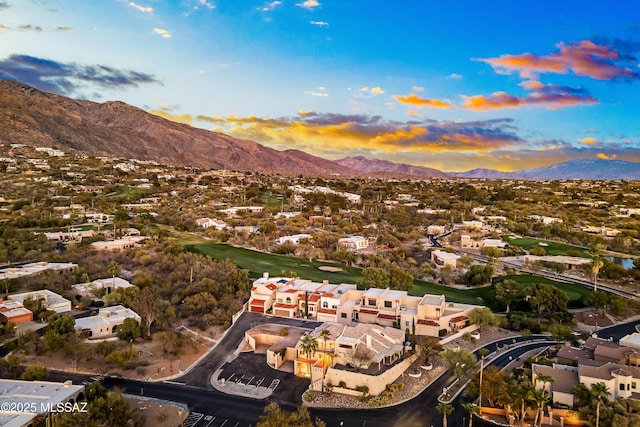 aerial view at dusk featuring a mountain view