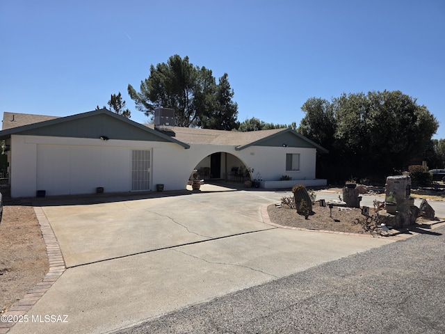 ranch-style home with driveway and a garage