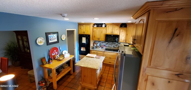 kitchen with tasteful backsplash, a kitchen island, a textured ceiling, and black appliances