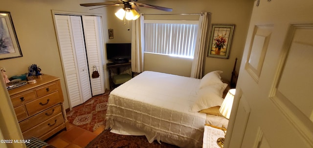 bedroom with ceiling fan and a closet