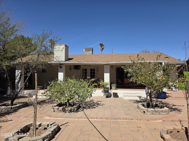 rear view of property featuring a patio and stucco siding