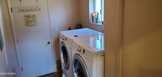 clothes washing area featuring laundry area and washer and clothes dryer