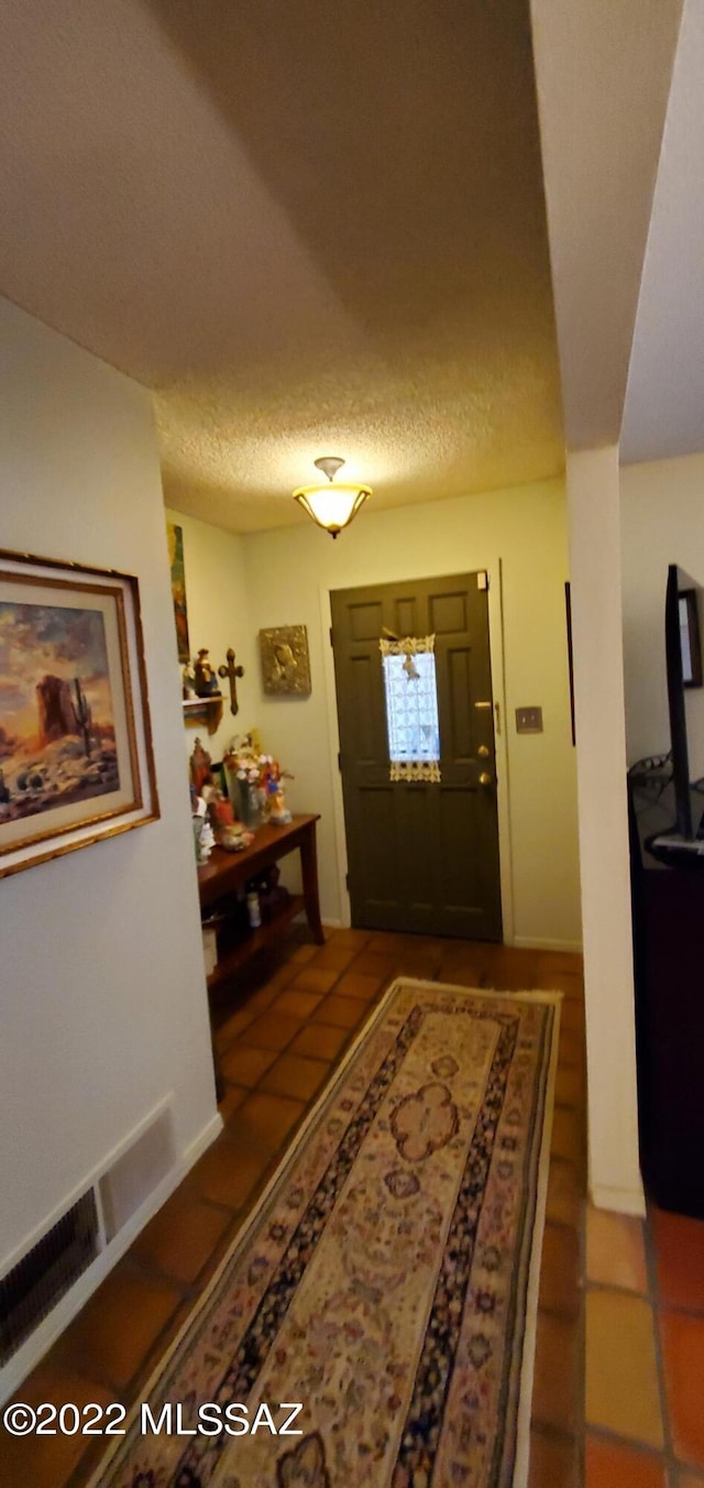 entrance foyer with a textured ceiling