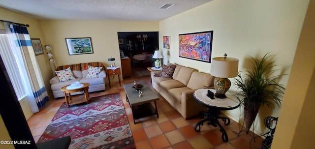 living area with a textured ceiling and visible vents