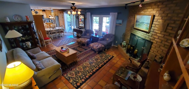 tiled living area with a brick fireplace and a ceiling fan