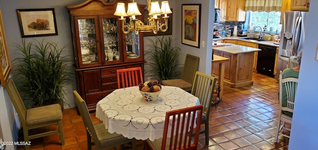 dining area with a notable chandelier and light tile patterned floors