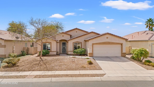 mediterranean / spanish home with driveway, an attached garage, a tiled roof, and stucco siding