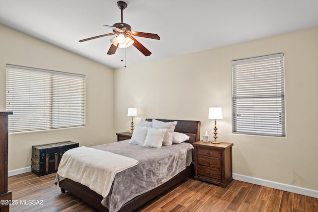 bedroom featuring lofted ceiling, ceiling fan, wood finished floors, and baseboards