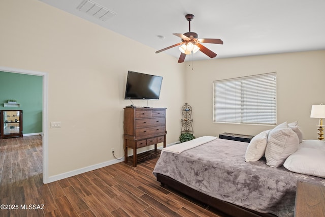 bedroom with a ceiling fan, dark wood finished floors, visible vents, and baseboards