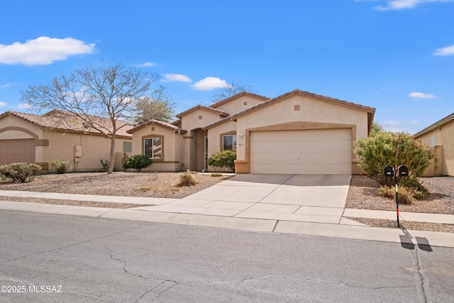mediterranean / spanish house with concrete driveway, a tiled roof, an attached garage, and stucco siding