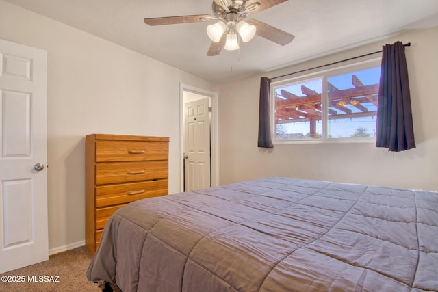 carpeted bedroom featuring a ceiling fan and baseboards