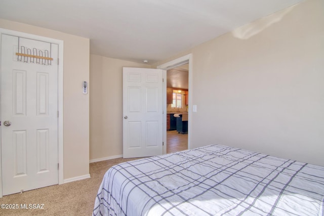 carpeted bedroom featuring baseboards