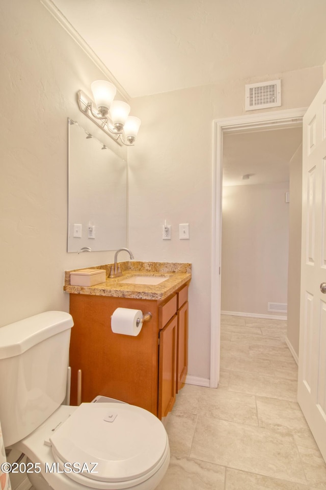 half bath with toilet, baseboards, visible vents, and vanity