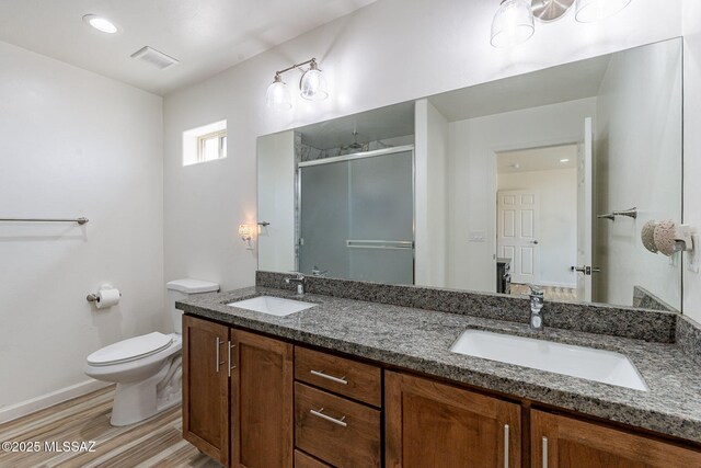 full bathroom featuring visible vents, a sink, toilet, and a shower stall